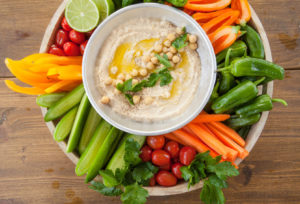 75309226 - homemade hummus with olive oil and fresh vegetables